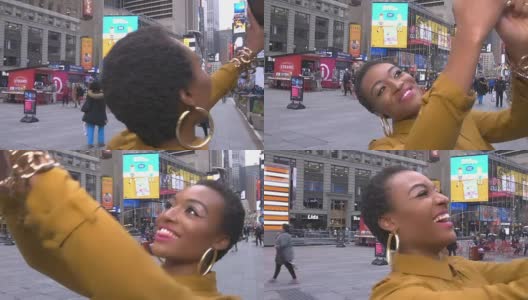 年轻的非洲裔美国女性戴着太阳镜在时代广场的美国国旗前自拍高清在线视频素材下载