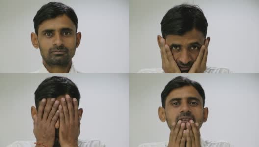 一名留着胡茬的印度男子看着镜头，在悲伤、绝望和痛苦中把手放在脸上高清在线视频素材下载