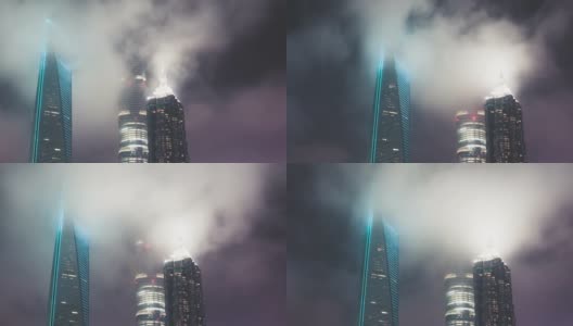 T/L PAN上海现代摩天大楼与夜间流动的雾高清在线视频素材下载