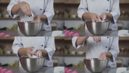 女糕点师在做蛋糕时往盘子里撒糖粉。围裙上的铭文，模特的名字叫尼娜·洛斯高清在线视频素材下载