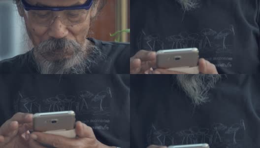 亚洲老人使用智能手机高清在线视频素材下载