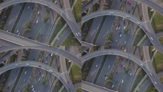 在阳光明媚的日子里，中国大都市成都的高架道路和交通枢纽的顶部向下角度的无人机视图。现代建筑设计的交通方式避免了交通堵塞，车辆众多高清在线视频素材下载