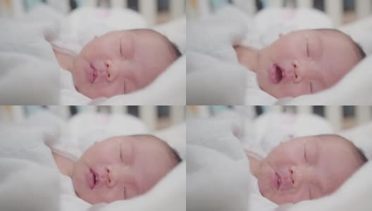 可爱的可爱的小新生儿的肖像脸婴儿在家里睡觉，幸福的新生儿在舒适的家在白天照明室内高清在线视频素材下载