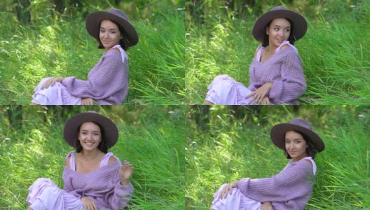 在一个阳光明媚的夏日，一个快乐的黑发年轻女子戴着帽子，流露出情感高清在线视频素材下载