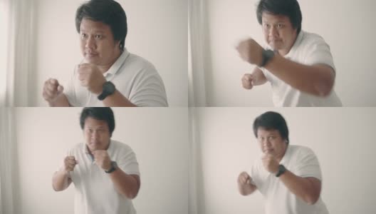 亚洲男子在家里进行拳击锻炼减肥高清在线视频素材下载