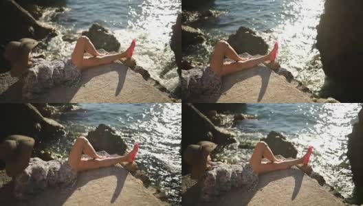 在悬崖上晒太阳的女人高清在线视频素材下载
