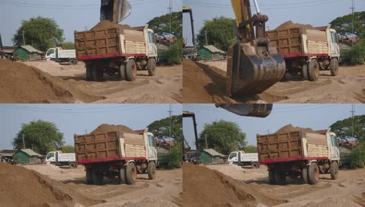 近距离观察正在把沙子装进卡车的挖土机高清在线视频素材下载