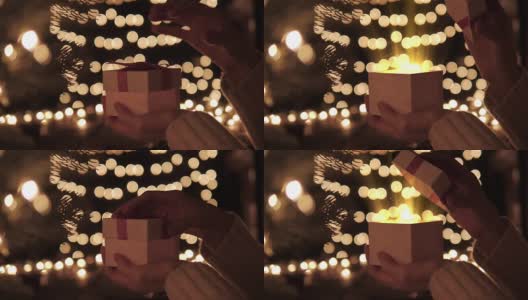 女人打开白色的圣诞礼盒与光芒的魔术灯散景灯的背景高清在线视频素材下载