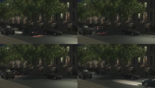 褐石建筑和汽车在夜间城市街道环线可高清在线视频素材下载