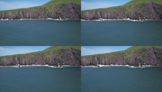 海面的航拍镜头由多岩石的小山悬崖面对高清在线视频素材下载