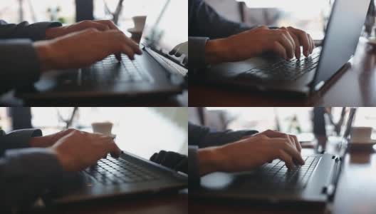 镜头在自由职业者在笔记本电脑键盘上打字的手周围以慢镜头移动。利用互联网在办公室工作的商人。背景是一杯咖啡。经营理念高清在线视频素材下载