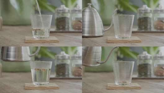 茶壶将热水倒入桌上的玫瑰茶杯中高清在线视频素材下载