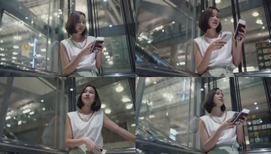 美女拿着智能手机和护照在透明电梯里高清在线视频素材下载