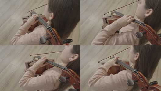 年轻的女音乐家拿着弓演奏大提琴，俯视图拍摄高清在线视频素材下载
