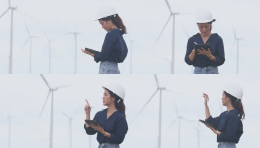 女性工程师使用平板电脑在风力涡轮机农场现场工作高清在线视频素材下载