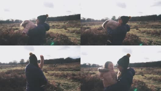 日落时分，妈妈和女儿在田野里玩耍高清在线视频素材下载