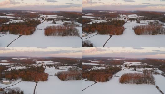 鸟瞰宾夕法尼亚州农村的农田在冬天，田野覆盖着雪，在黄昏。高清在线视频素材下载