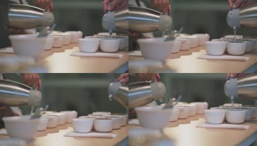 近距离观看专业亚洲华人咖啡师将热水倒入陶瓷咖啡杯中准备拔杯咖啡品质测试高清在线视频素材下载