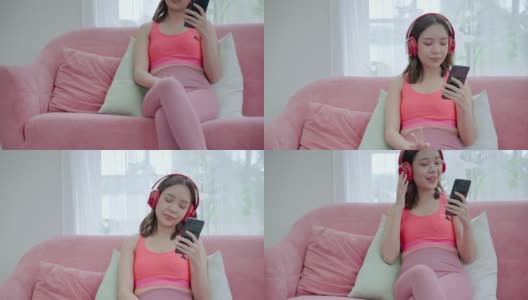 一名身穿运动服的年轻亚洲女子在锻炼休息时使用智能手机和耳机使用社交媒体。高清在线视频素材下载