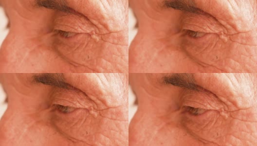 70岁以上的白人男性的眉毛和皱纹的眼睛的特写。一个退休老人悲伤的眼神，特写镜头。选择性对焦，景深浅高清在线视频素材下载