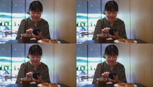 亚洲女性在咖啡馆喝咖啡休息时使用智能手机高清在线视频素材下载