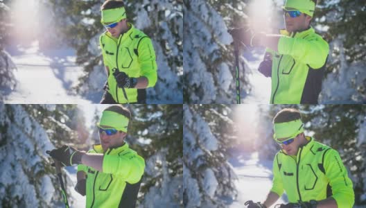 男运动员在冬季景观，查看智能手表高清在线视频素材下载
