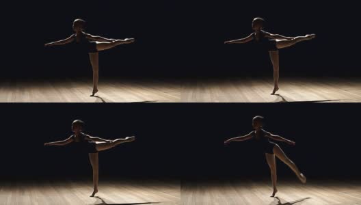 一个年轻的芭蕾舞者在黑色背景上摆姿势。高清在线视频素材下载