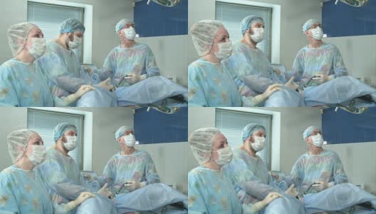 在医院的手术室里，一组医生在一起做手术高清在线视频素材下载