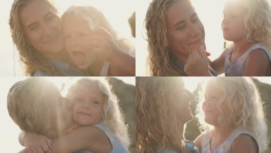 快乐的金发妈妈和可爱的女儿一起在日出的海滩上散步高清在线视频素材下载