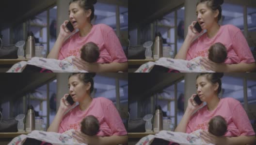 亚洲妈妈工作到深夜，抱着孩子睡觉。高清在线视频素材下载