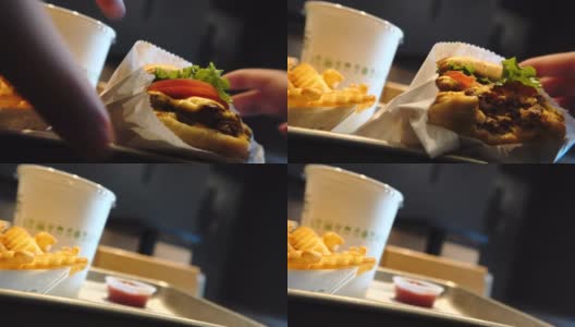 吃一个奶酪汉堡汉堡包西红柿生菜薯条薯条高清在线视频素材下载