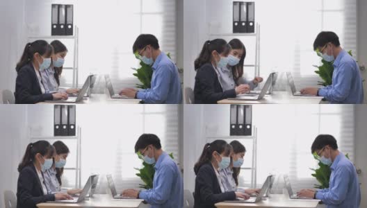办公室会议新常态:办公室人员带口罩工作高清在线视频素材下载
