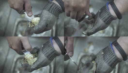 员工用特制短刀在水槽上剥牡蛎壳高清在线视频素材下载