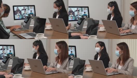 年轻的亚洲员工和资深的办公室员工团队通过电脑进行Zoom视频电话会议，商务人士共用办公桌使用电脑共同工作。高清在线视频素材下载