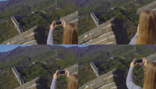 2018年10月29日，中国北京:一名女子用手机拍摄中国长城的慢动作照片，长城在山的一侧开始倒塌高清在线视频素材下载