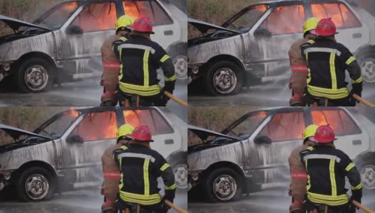 后视图亚洲消防队员操作消防软管在一辆汽车高清在线视频素材下载