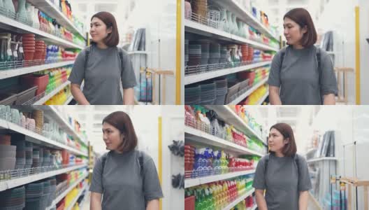 一位女士推着购物车在超市里购物高清在线视频素材下载