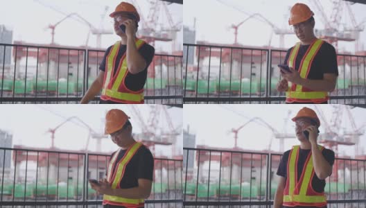 建筑工人亚洲人用智能手机操作。控制工人建造一座大楼。6、安全帽，防止事故发生。电话会议在工作高清在线视频素材下载