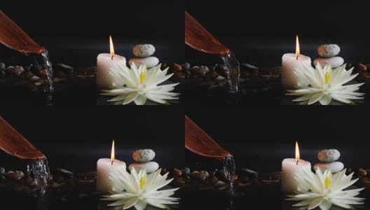 Spa的背景是白色的莲花，睡莲花，平衡的石头和燃烧的蜡烛高清在线视频素材下载