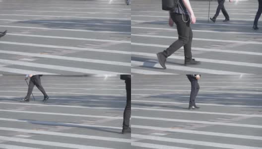 一群不认识的人走在街上，腿中弹。缓慢的运动。高清在线视频素材下载