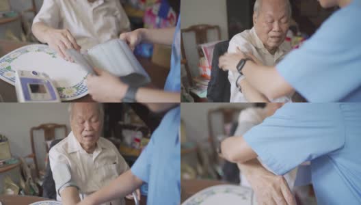 家庭护士试图给成年老人做血压测试高清在线视频素材下载