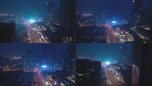 夜光照亮了青岛市区著名的商场、交通街道，航拍了4k中国全景高清在线视频素材下载