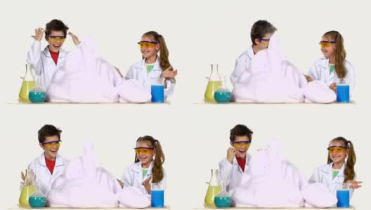 两个可爱的化学家孩子做有趣和成功的实验泡沫隔离在白色背景，慢动作高清在线视频素材下载