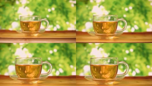 绿色背景的玻璃茶杯高清在线视频素材下载