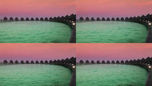 日出时，海面上的房屋。马尔代夫高清在线视频素材下载