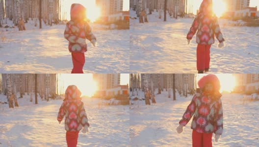 一个小女孩在森林里朝着冬日的夕阳走去高清在线视频素材下载