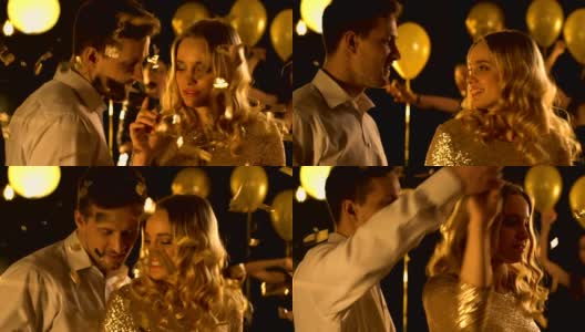 漂亮的白人情侣在飘落的五彩纸屑下跳舞，一起庆祝高清在线视频素材下载