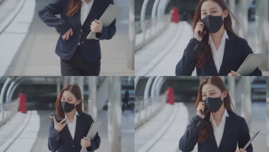 年轻的女商人在办公室外工作时要戴上防护口罩高清在线视频素材下载