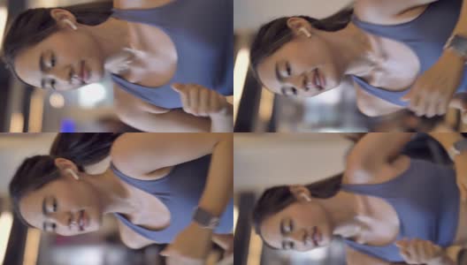 年轻漂亮的女人在健身房锻炼在跑步机上跑步高清在线视频素材下载