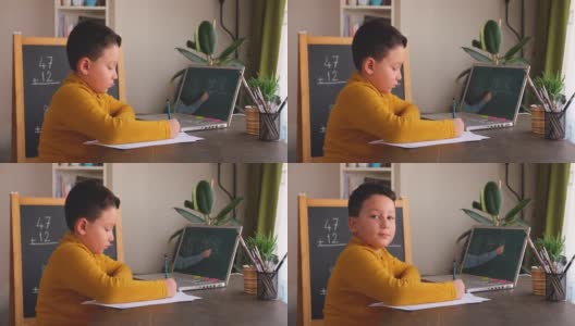 6-7岁可爱的孩子从电脑学习数学。学习在家里。在线教育高清在线视频素材下载